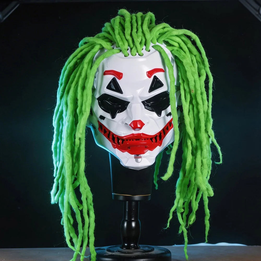 A Joker costume mask with bright green dreadlocks, displayed on a black stand against a dark background.